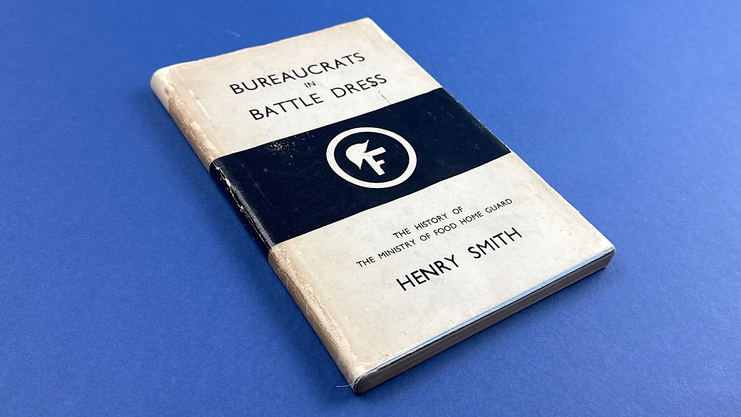 Angled front view of Bureaucrats in Battledress, displaying spine wear and surface marks on the cover