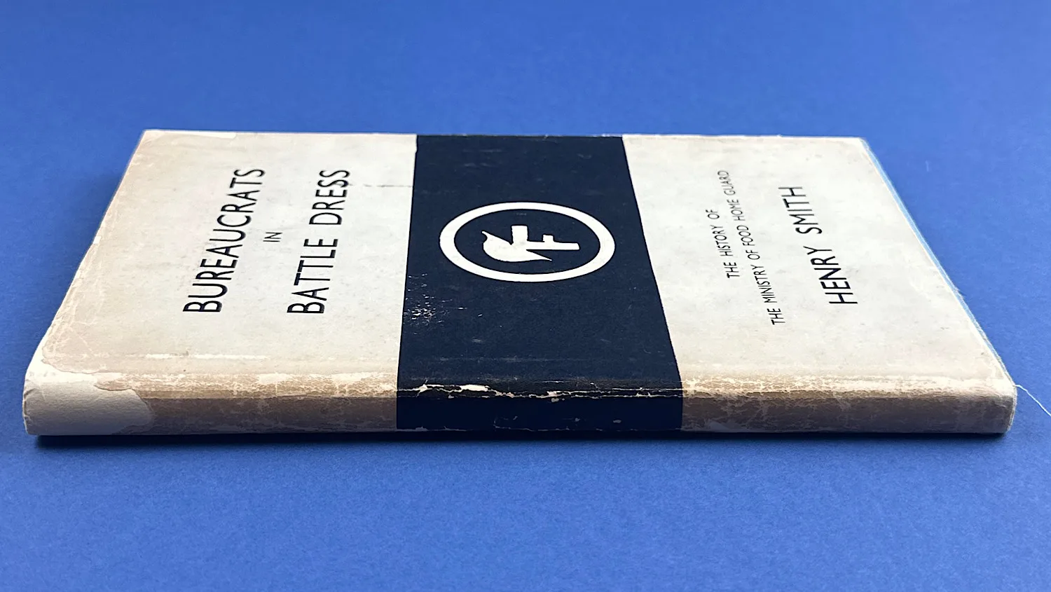 Side view of Bureaucrats in Battledress showing spine condition and wear along the edges of the card covers