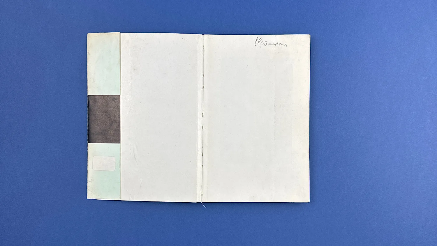 Inside front cover of Bureaucrats in Battledress, showing clean pages and the book’s stitched spine