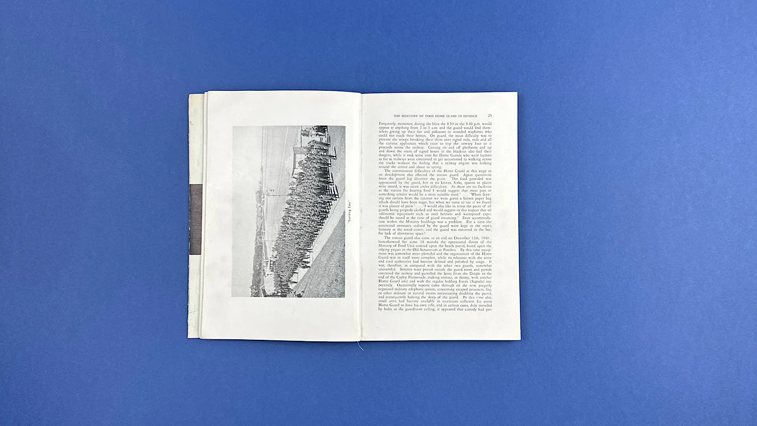 Open pages of Bureaucrats in Battledress displaying a full-page photograph and accompanying text