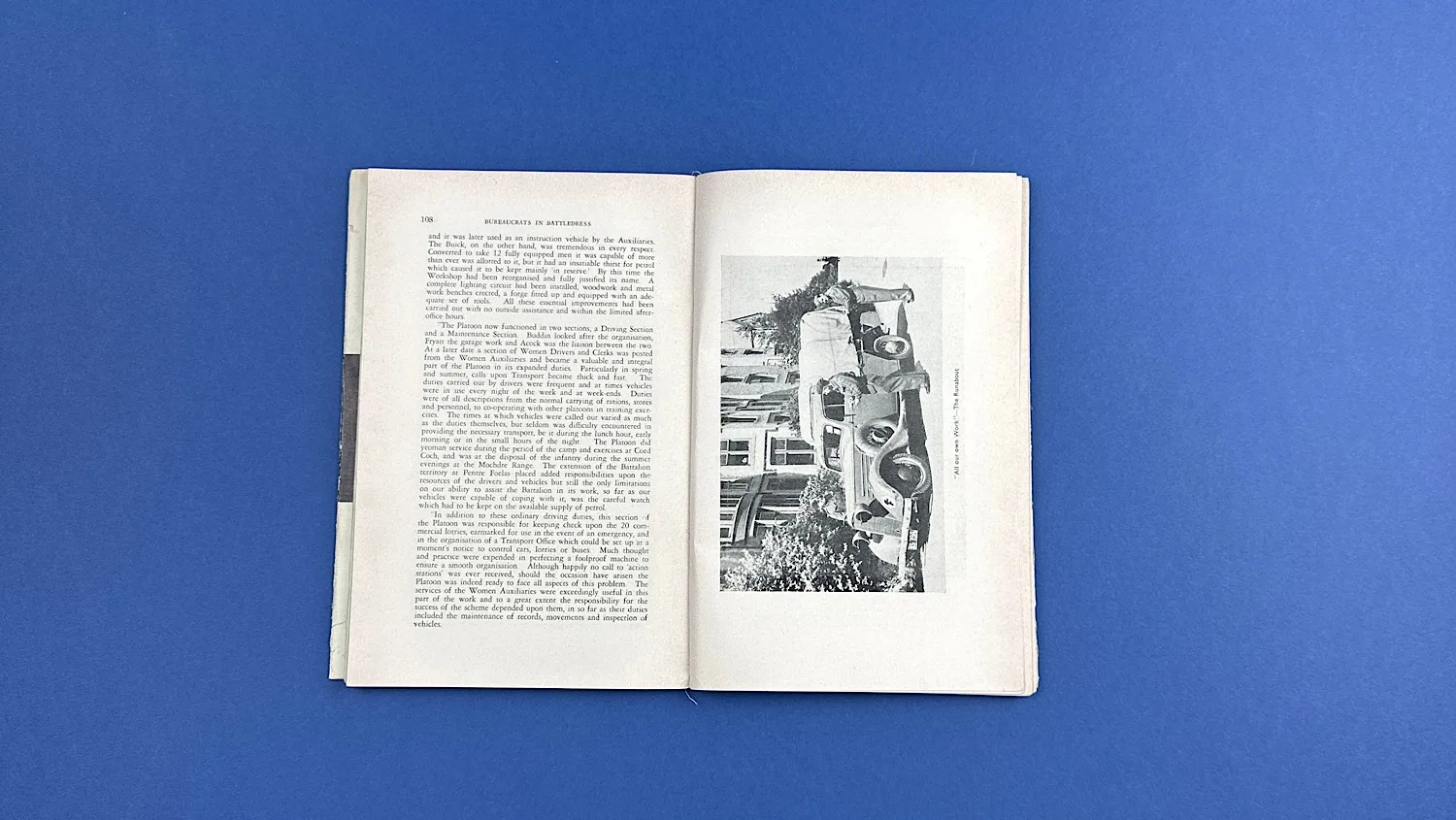 Open pages of Bureaucrats in Battledress showing text and a photograph of a covered vehicle used by the unit
