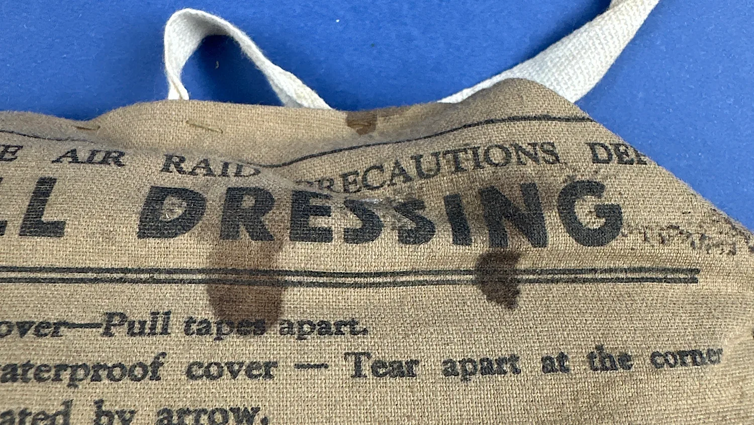 Close-up of stains and printed text on the upper section of the 1938 ARP Shell Dressing