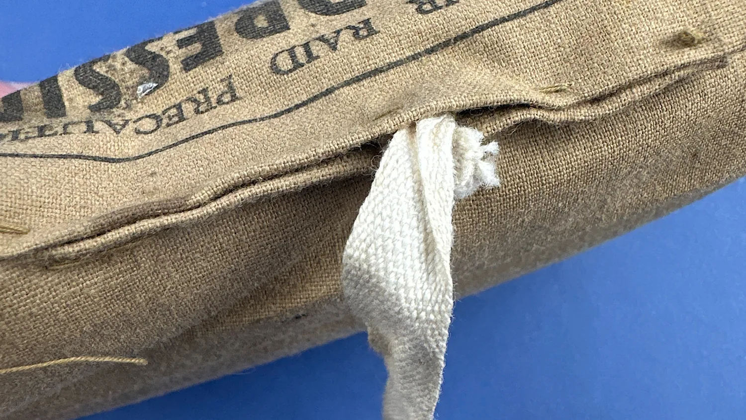 Detail of the white cloth tie attached to the unopened 1938 ARP Shell Dressing