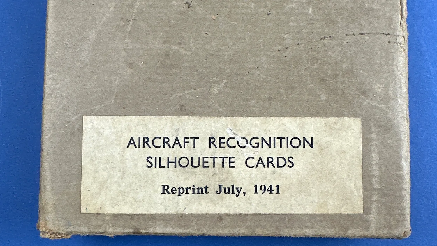 Close-up of the printed label on the Aircraft Recognition Silhouette Cards box showing age wear to the surface