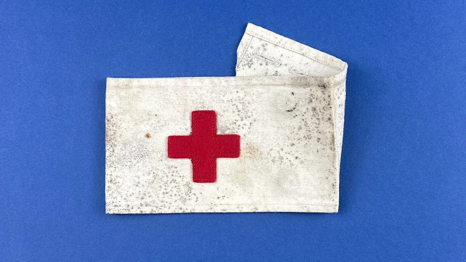 Original WW2 United States medical armband with sewn red felt cross on cotton fabric