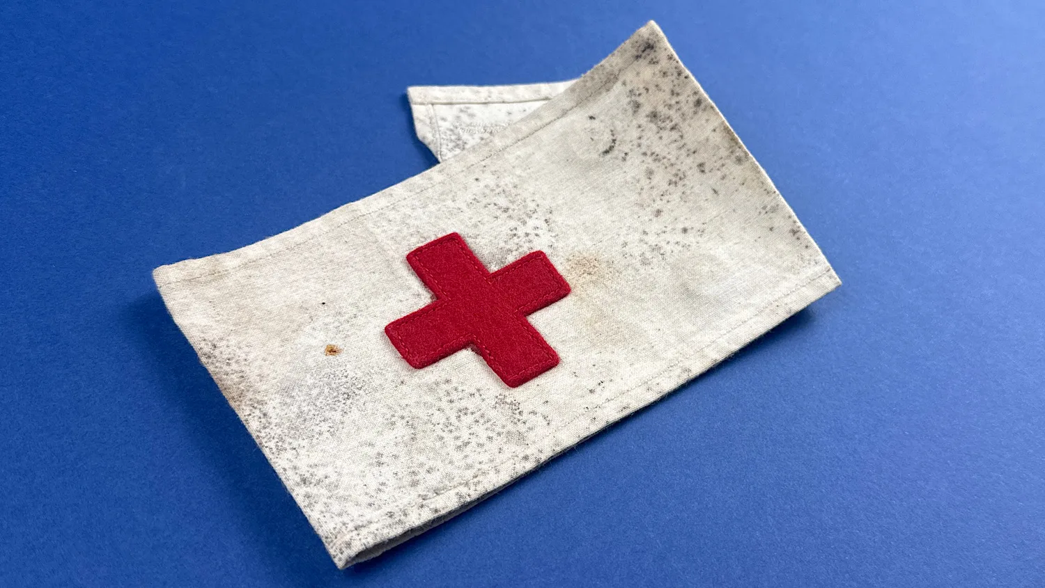 Angled view of WW2 US medical armband showing felt red cross and overall construction
