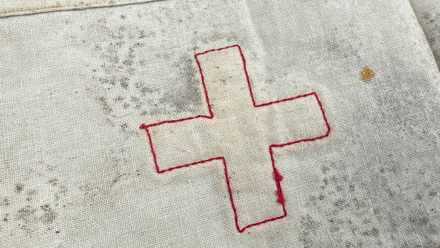 Full reverse view of WW2 US medical armband with outline cross and button fastening