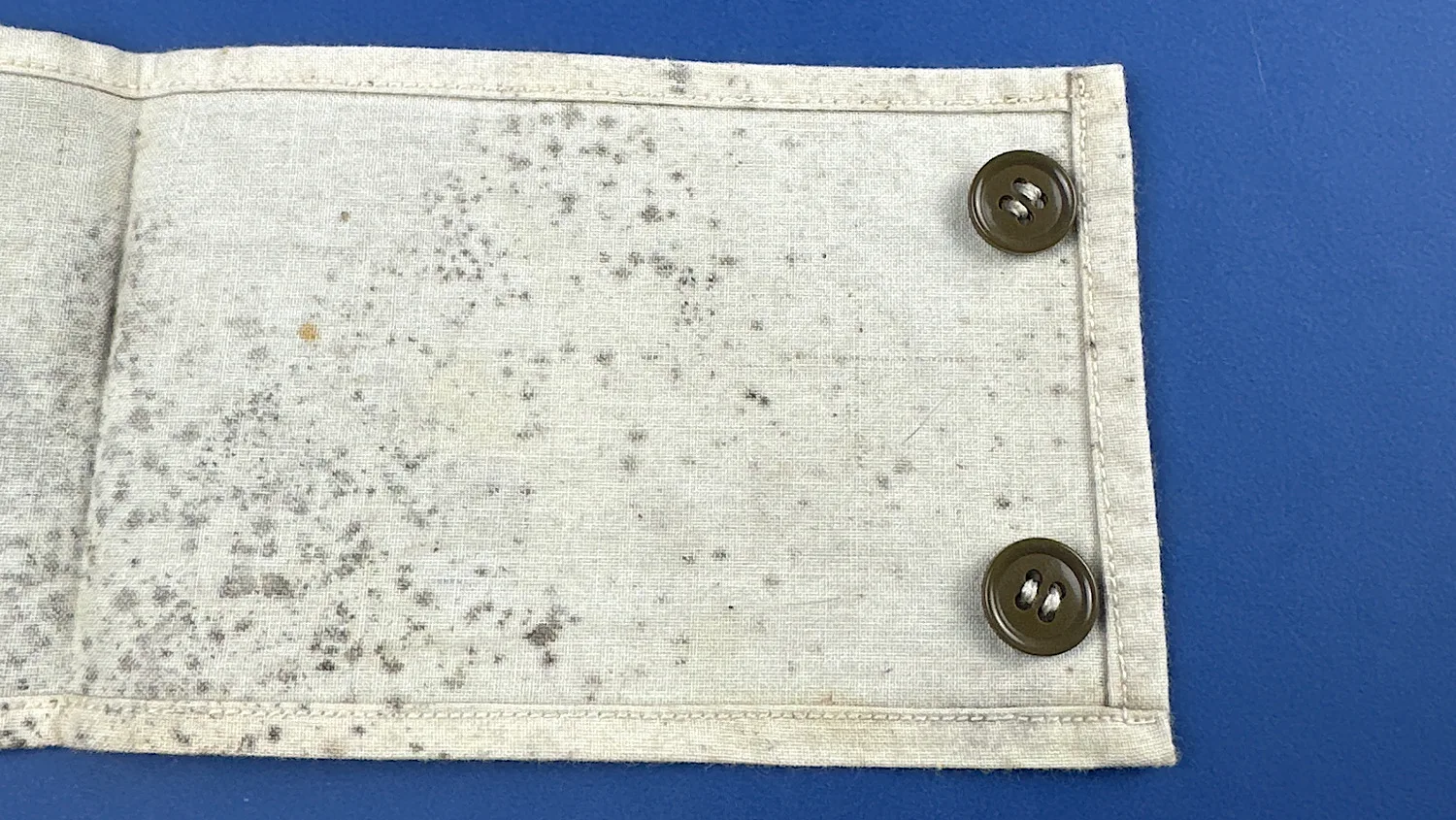 Detail view of original plastic buttons on WW2 US medical armband