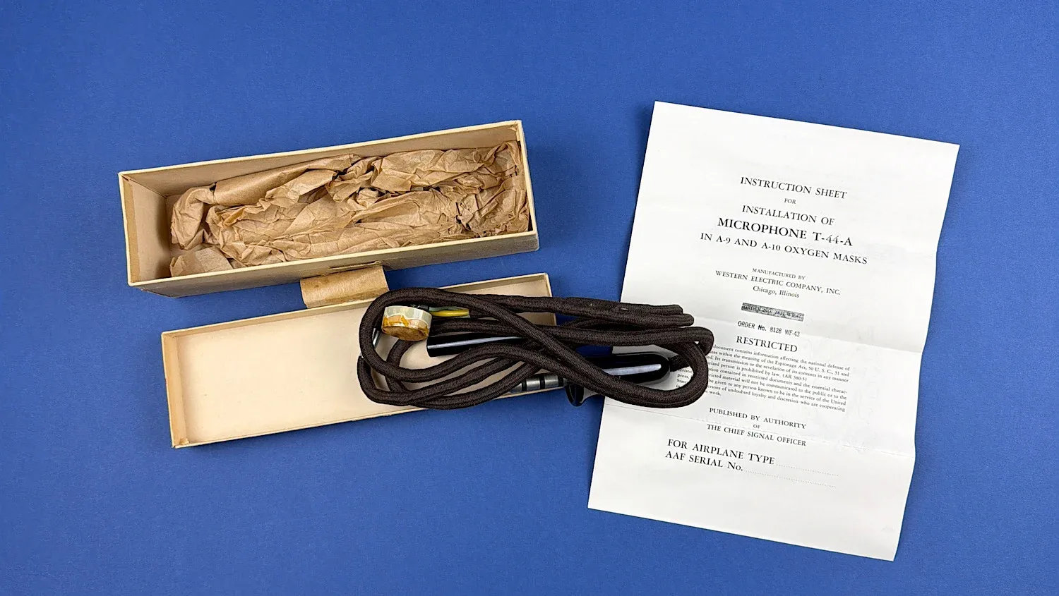 WW2 USAAF T-44-A throat microphone with original cardboard issue box dated 8 May 1943 and printed instruction sheet laid out together