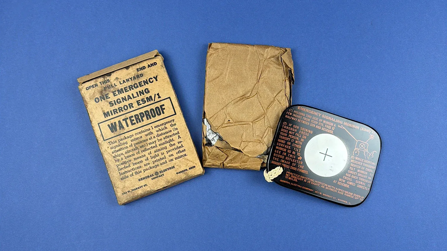 Original WW2 U.S. Emergency Signaling Mirror ESM/1 with waterproof packet lanyard and inner wrapping shown disassembled