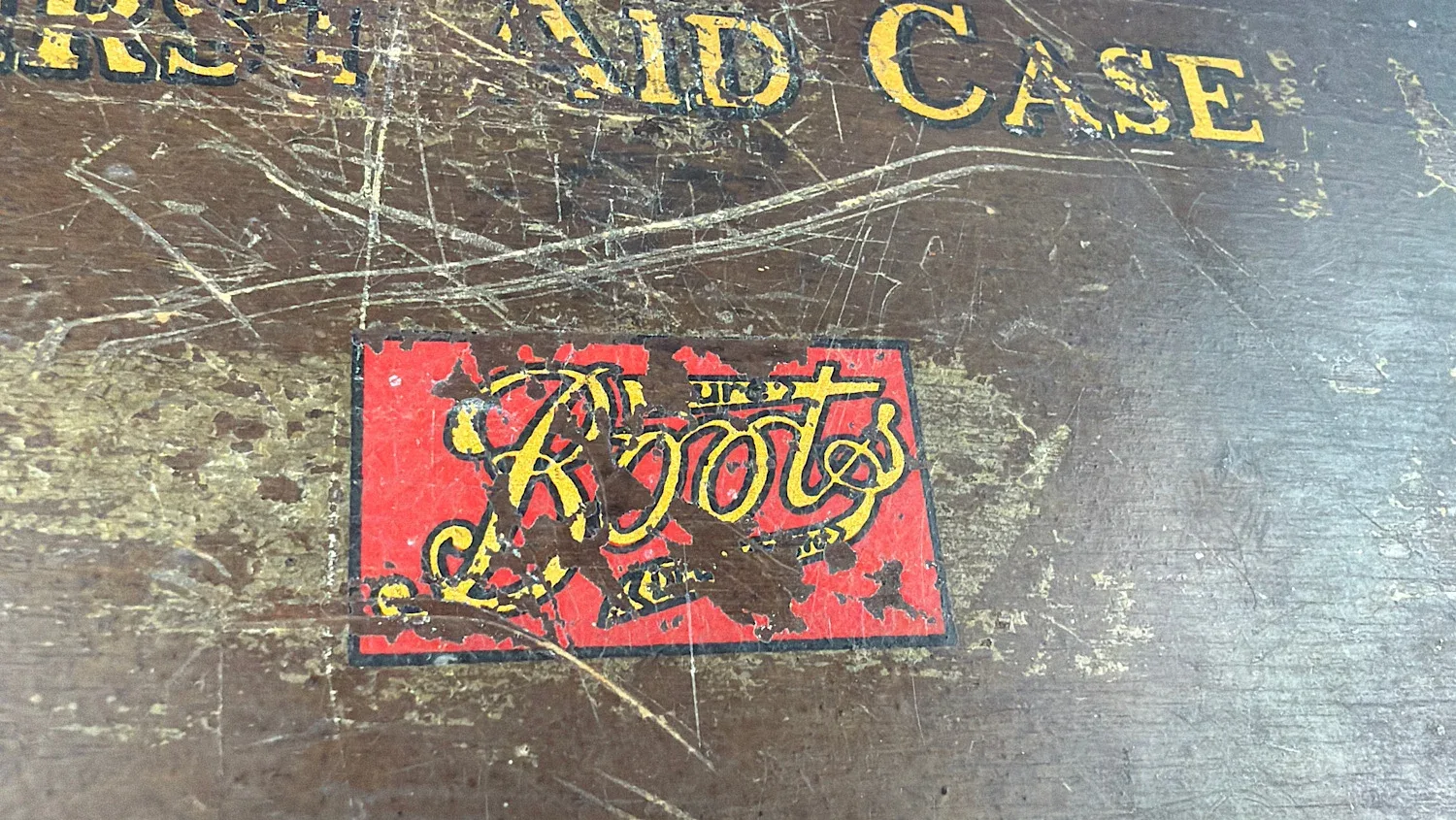 Close up of original Boots logo on British Home Front “Home” First Aid Case showing period branding and surface wear