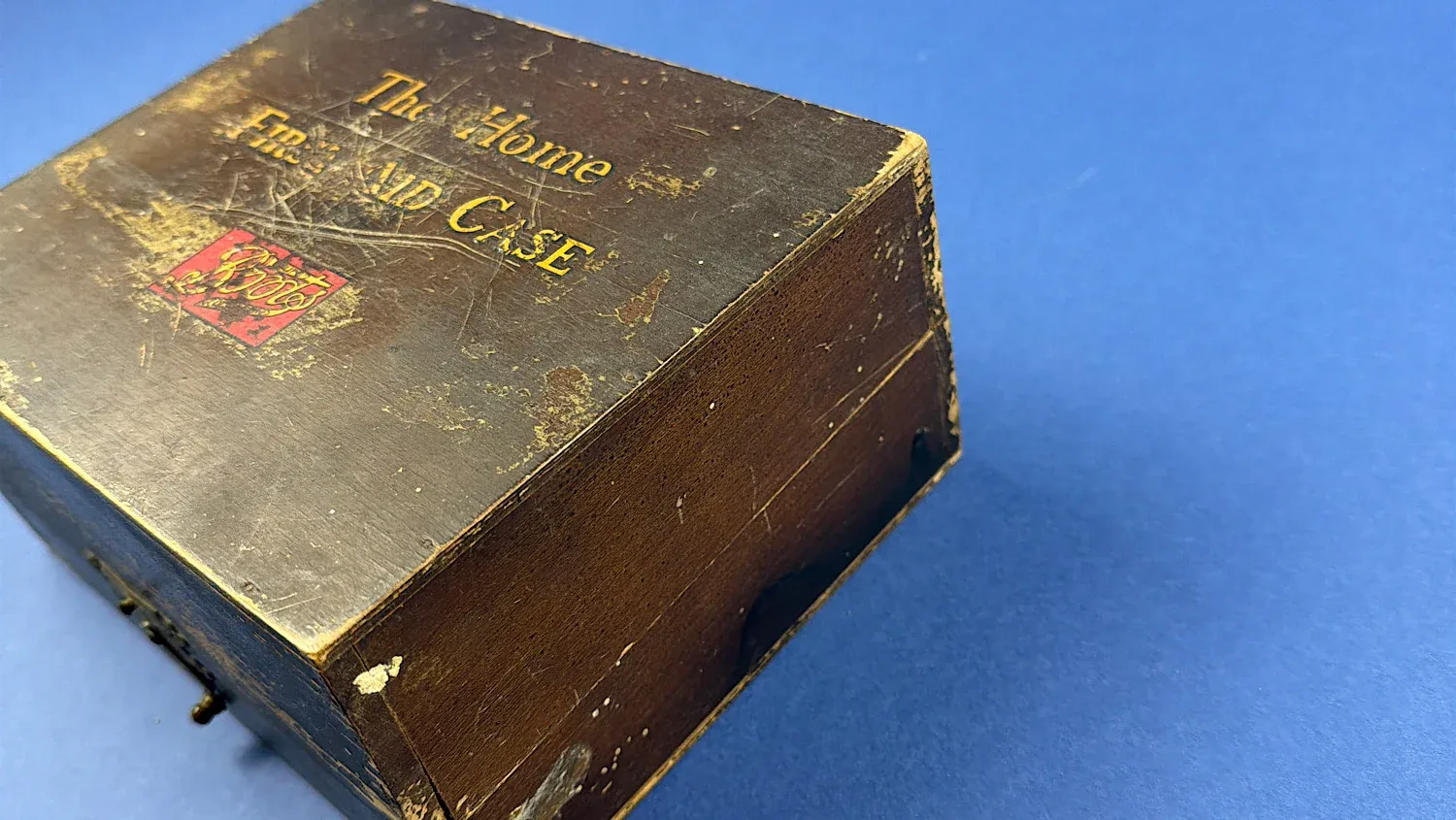 British Home Front Boots “Home” First Aid Case wooden box shown from angled view highlighting original finish and period wear