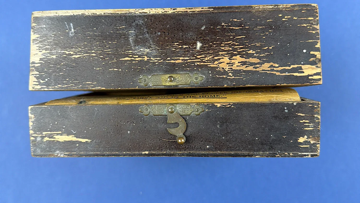 British Home Front Boots “Home” First Aid Case front edge showing original brass latch and aged painted surface