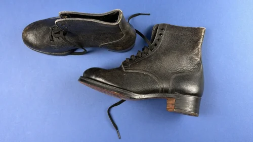 Original WW2 Women’s Land Army boots side profile showing pebbled black leather uppers and full lace fastening
