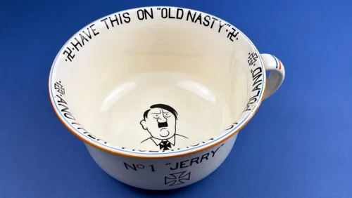 WW2 British Home Front anti-Hitler chamber pot by Crown Devon Fieldings showing interior caricature and rim slogan “Have This on Old Nasty”