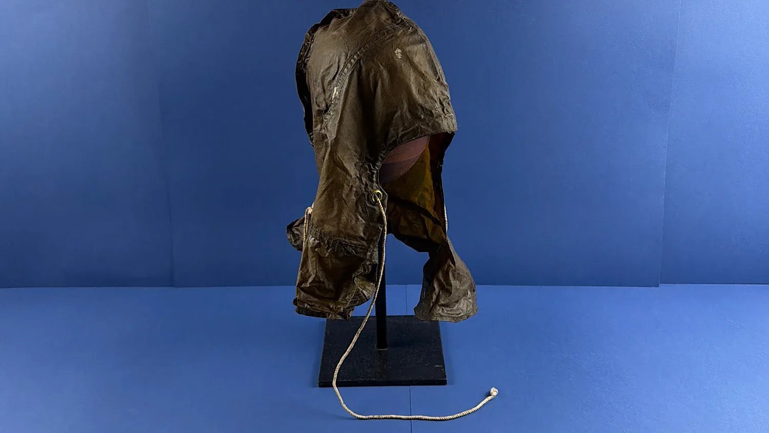 WW2 British ARP anti gas protective hood displayed on stand showing full Home Front Civil Defence form with draw cord and skirted lower section