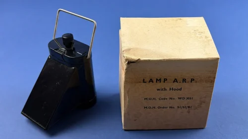 WW2 British Home Front ARP blackout lamp with hood beside original Ministry of Health WD 3051 issue box