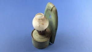 WW2 era British wall mounted paraffin lamp with green painted metal reflector plate and opal glass shade