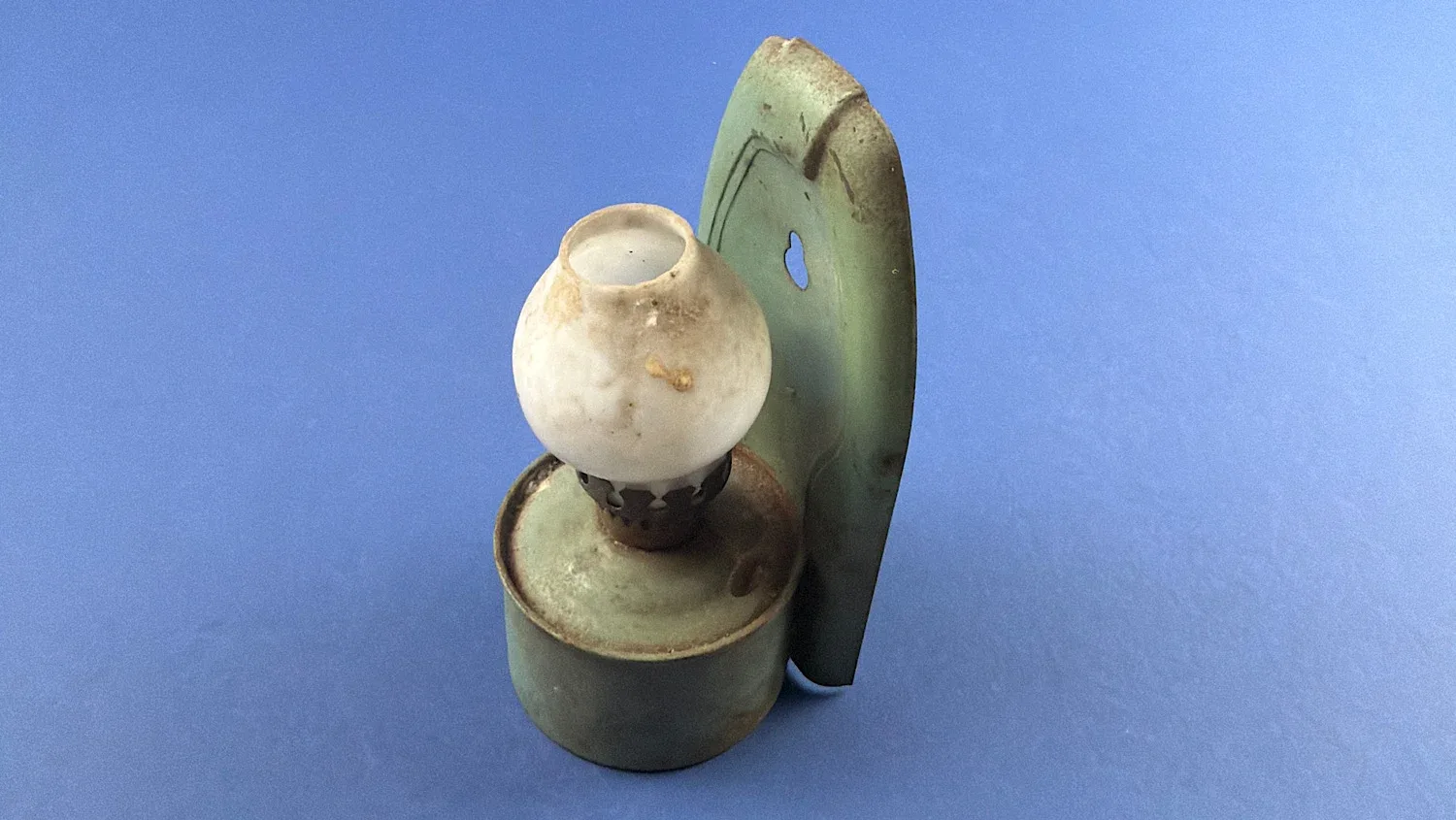 WW2 era British wall mounted paraffin lamp with green painted metal reflector plate and opal glass shade