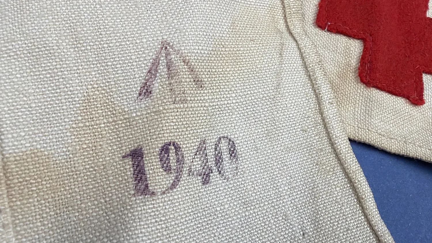 Close up of 1940 date stamp and Broad Arrow marking on WW2 British Red Cross armband