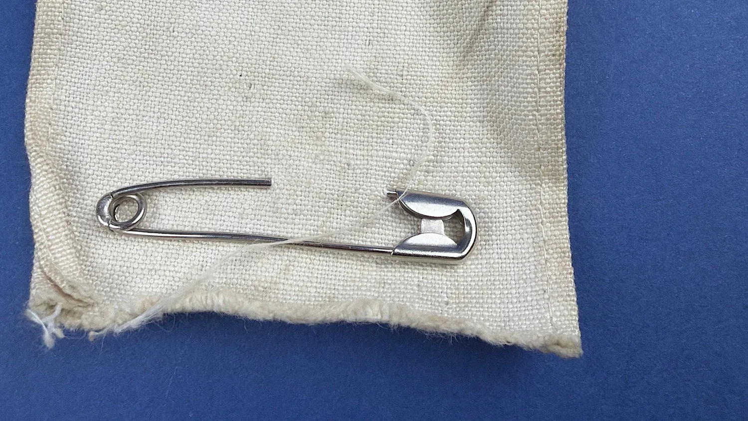 Close up of safety pin fastening attached to WW2 British Red Cross armband