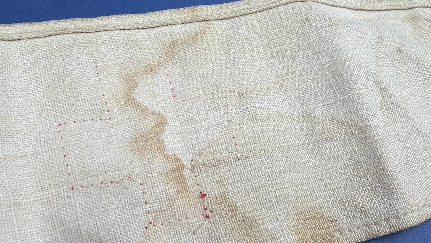Close up of reverse side showing stitch marks where red cross was previously attached on WW2 British armband