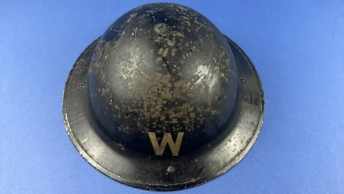 WW2 British Air Raid Warden steel helmet with white W marking Home Front ARP helmet front view showing rust patina