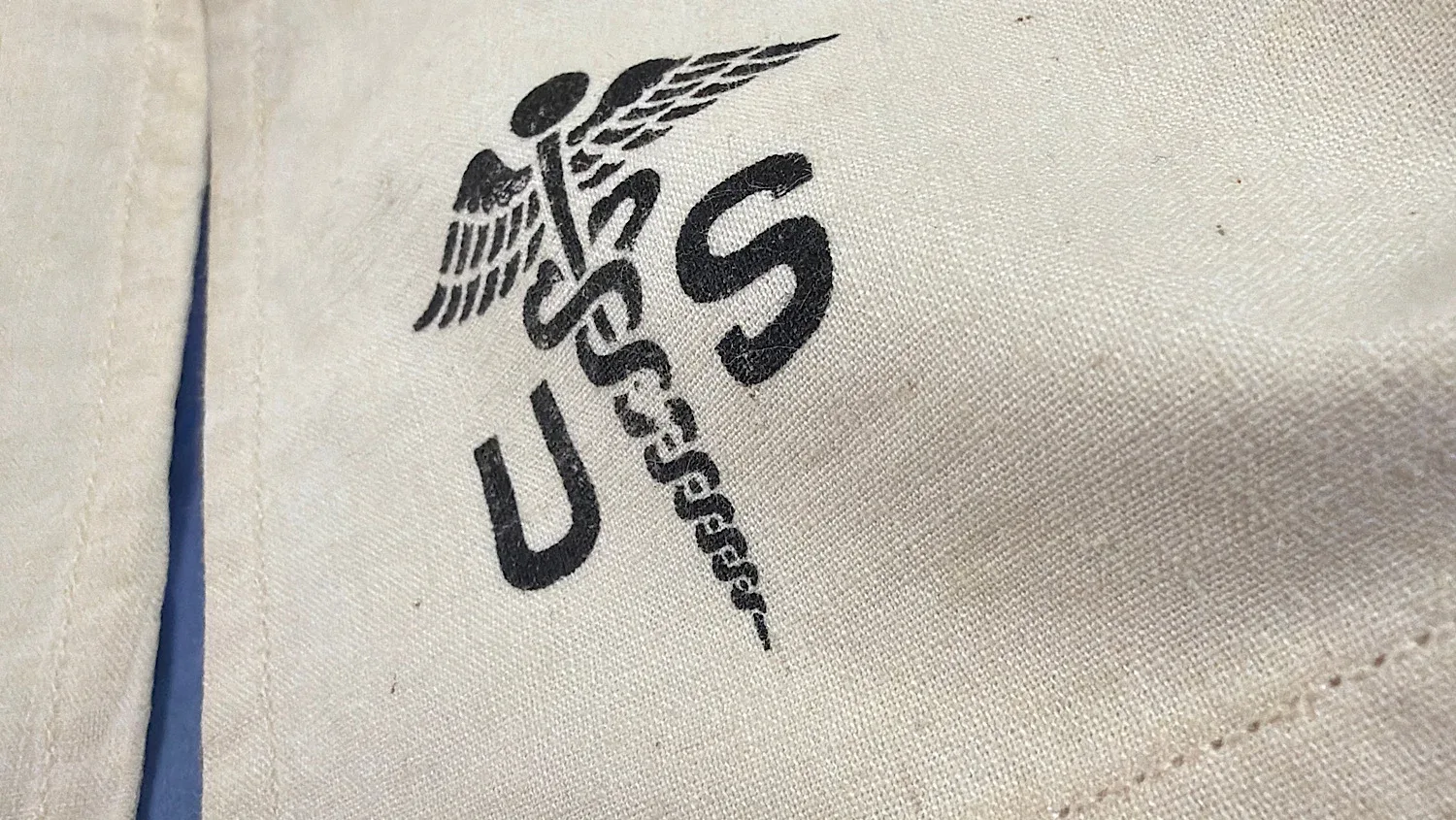 WW2 US Medical Corps caduceus marking close up showing crisp U.S. stencil and fabric detail