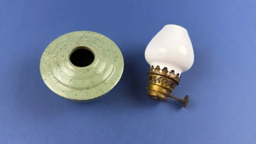 WW2 Era British Home Front paraffin lamp with green enamelled base, white glass shade and brass burner parts displayed disassembled