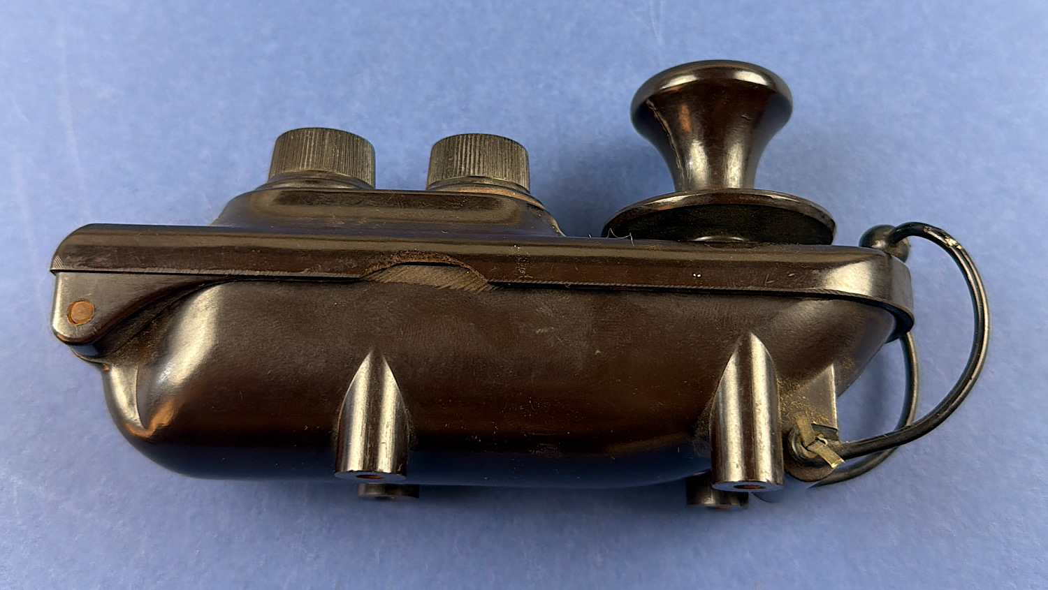 Side view of the WW2 RAF Bathtub Morse key showing the rounded casing and wire loop