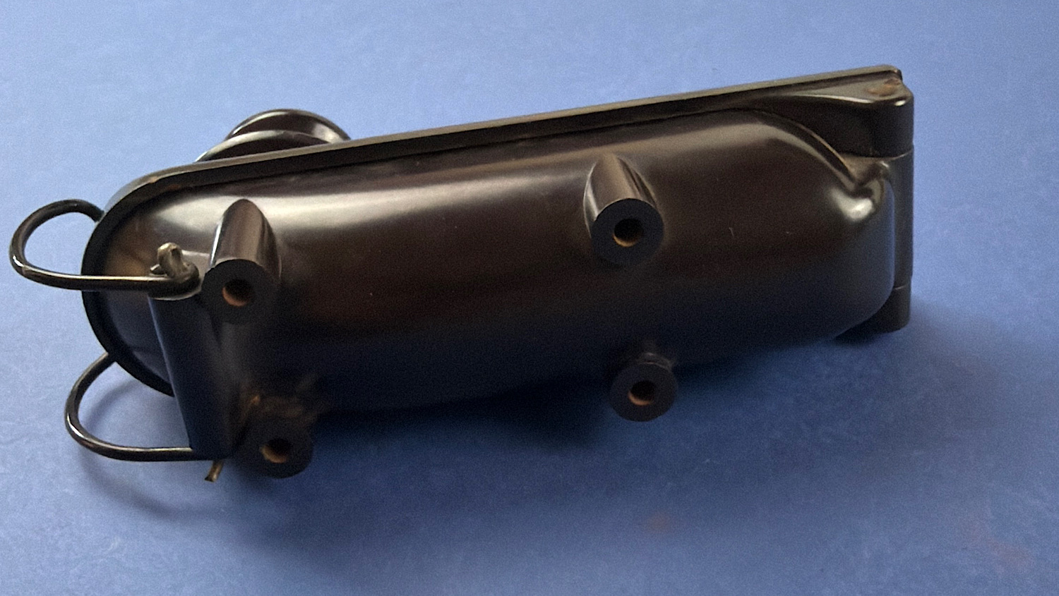 Underside view of an original WW2 RAF Bathtub Morse key showing the black casing, mounting feet and rear wire loop connector