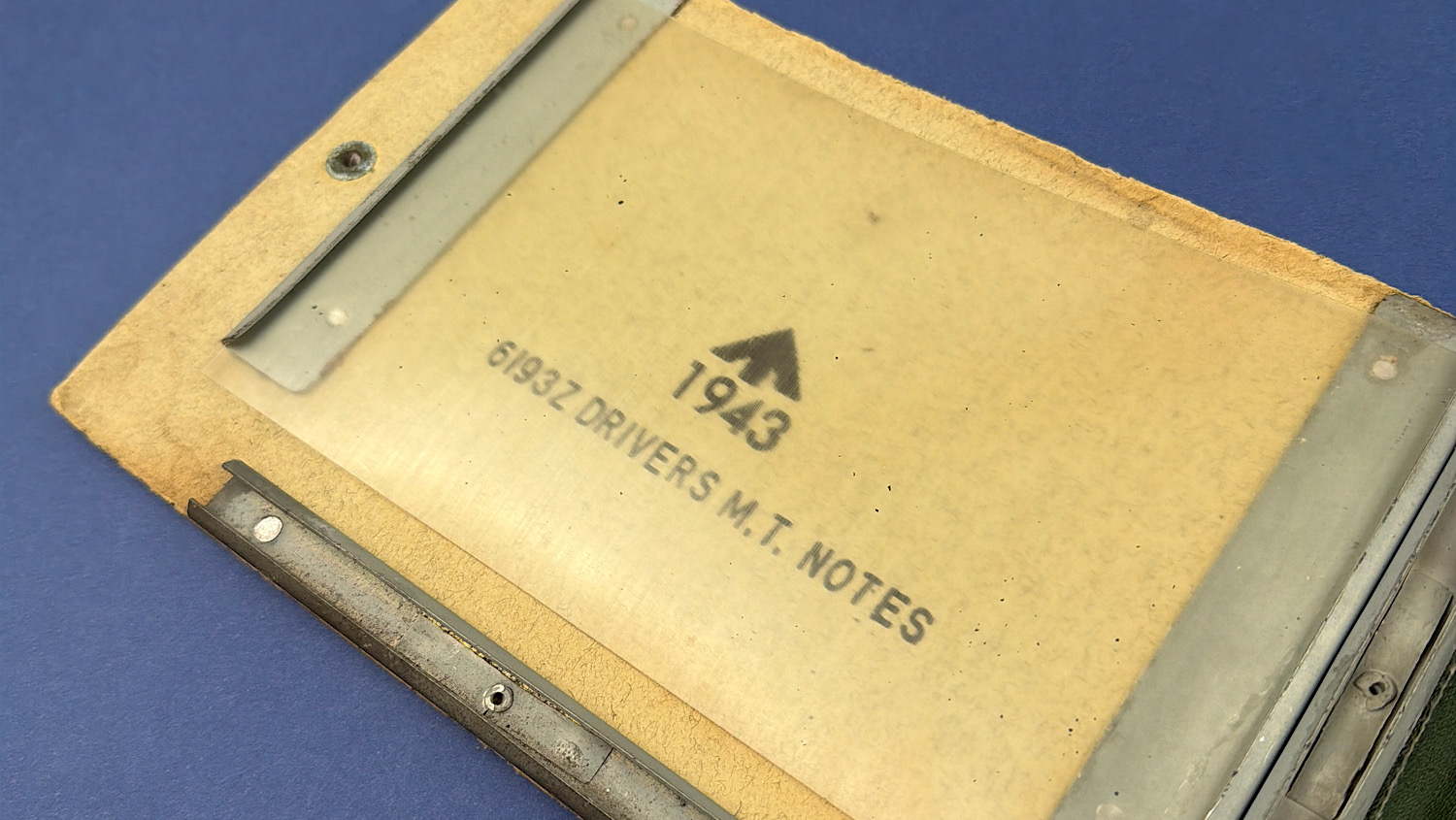 Angled view of WW2 British Drivers M.T. Notes sleeve showing printed marking and clear plastic screen