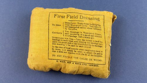 WW2 British First Field Dressing in original unopened khaki wrapper with printed instructions visible