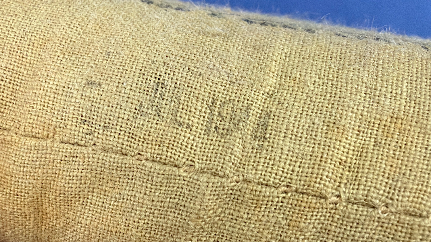 Close-up of faint July 1944 date stamp on unopened WW2 British First Field Dressing wrapper
