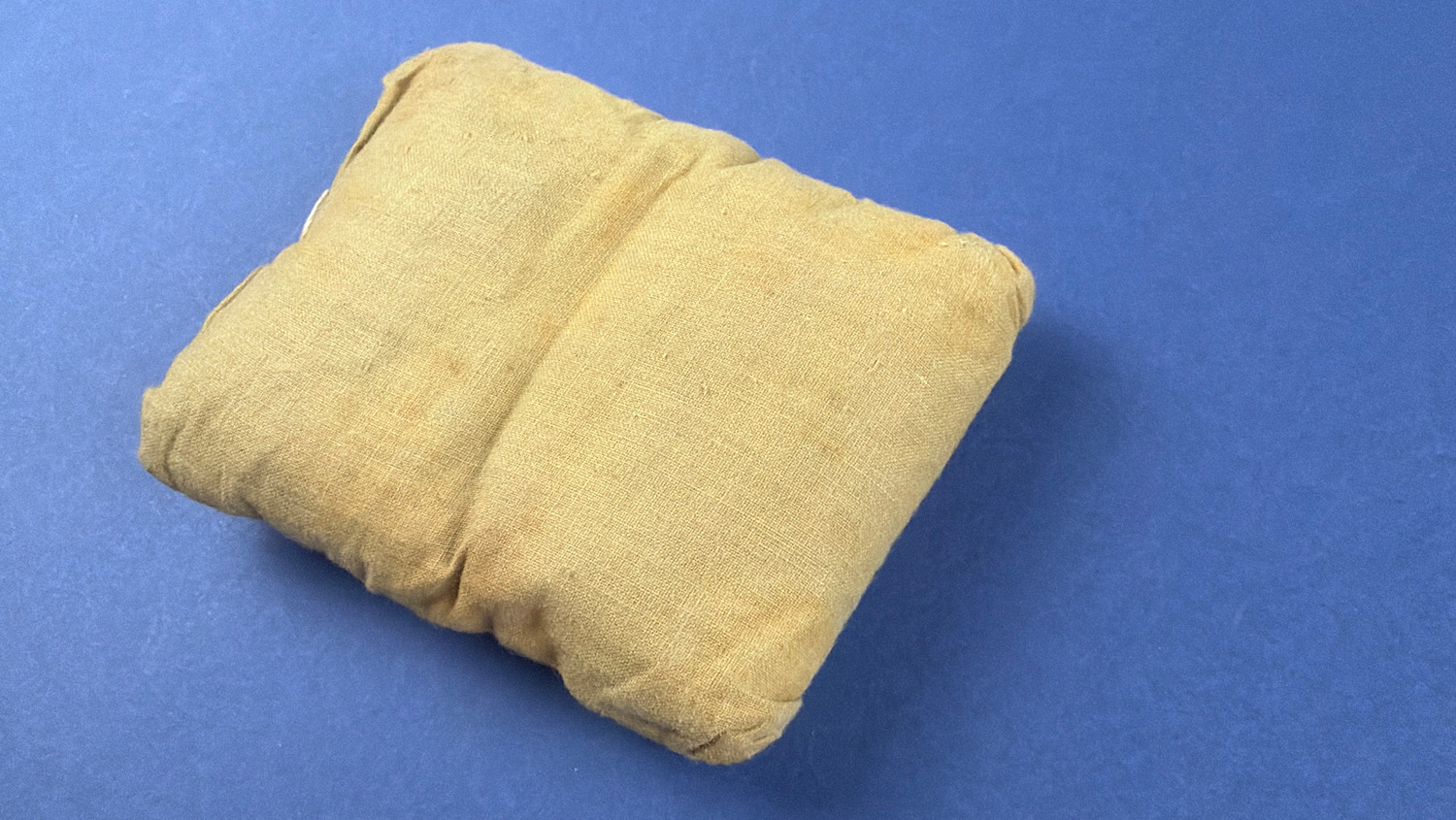 WW2 British First Field Dressing reverse view showing original unopened khaki wrapper