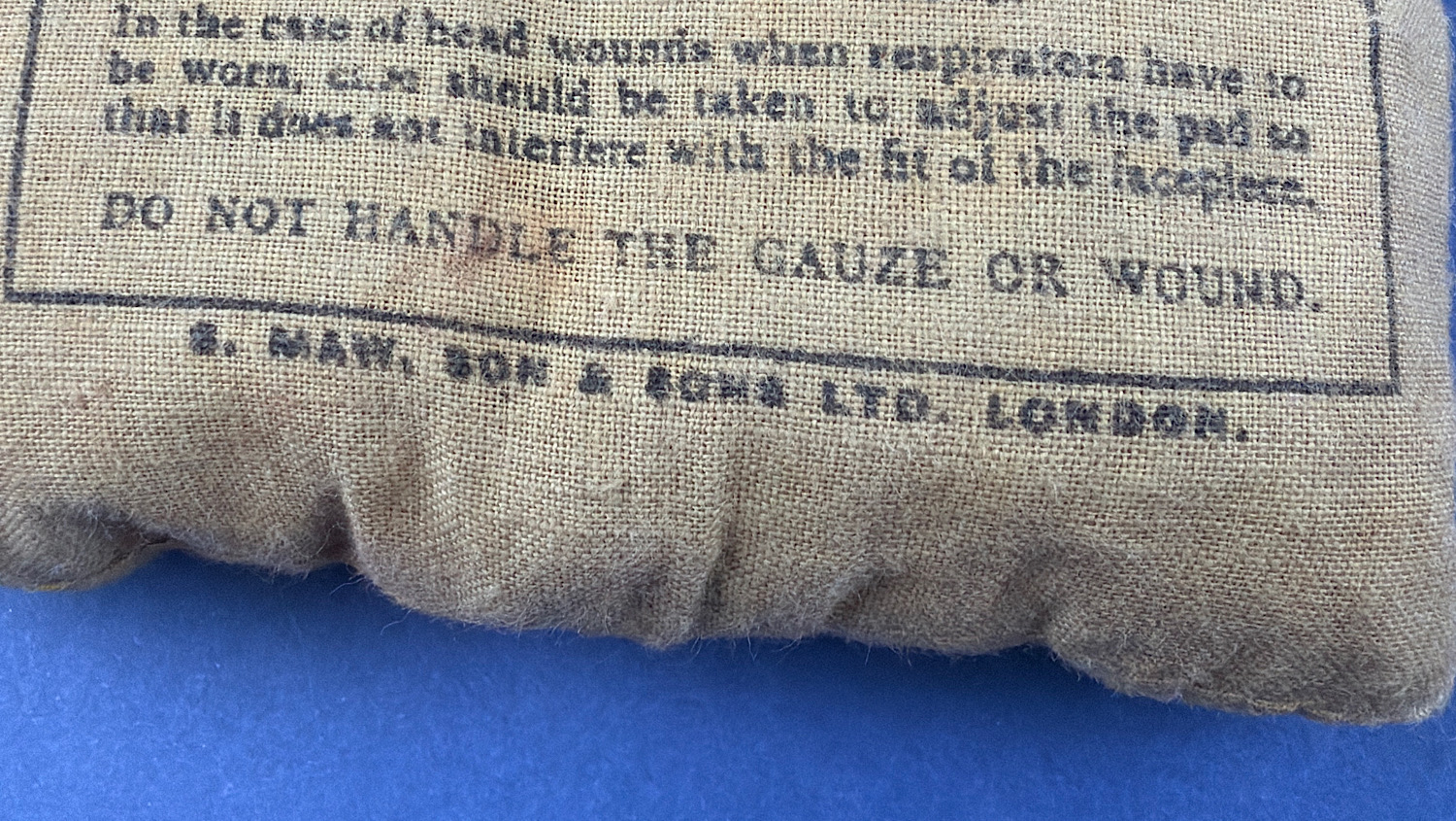 Close-up of S. Maw, Son & Sons Ltd London manufacturer marking on WW2 First Field Dressing wrapper