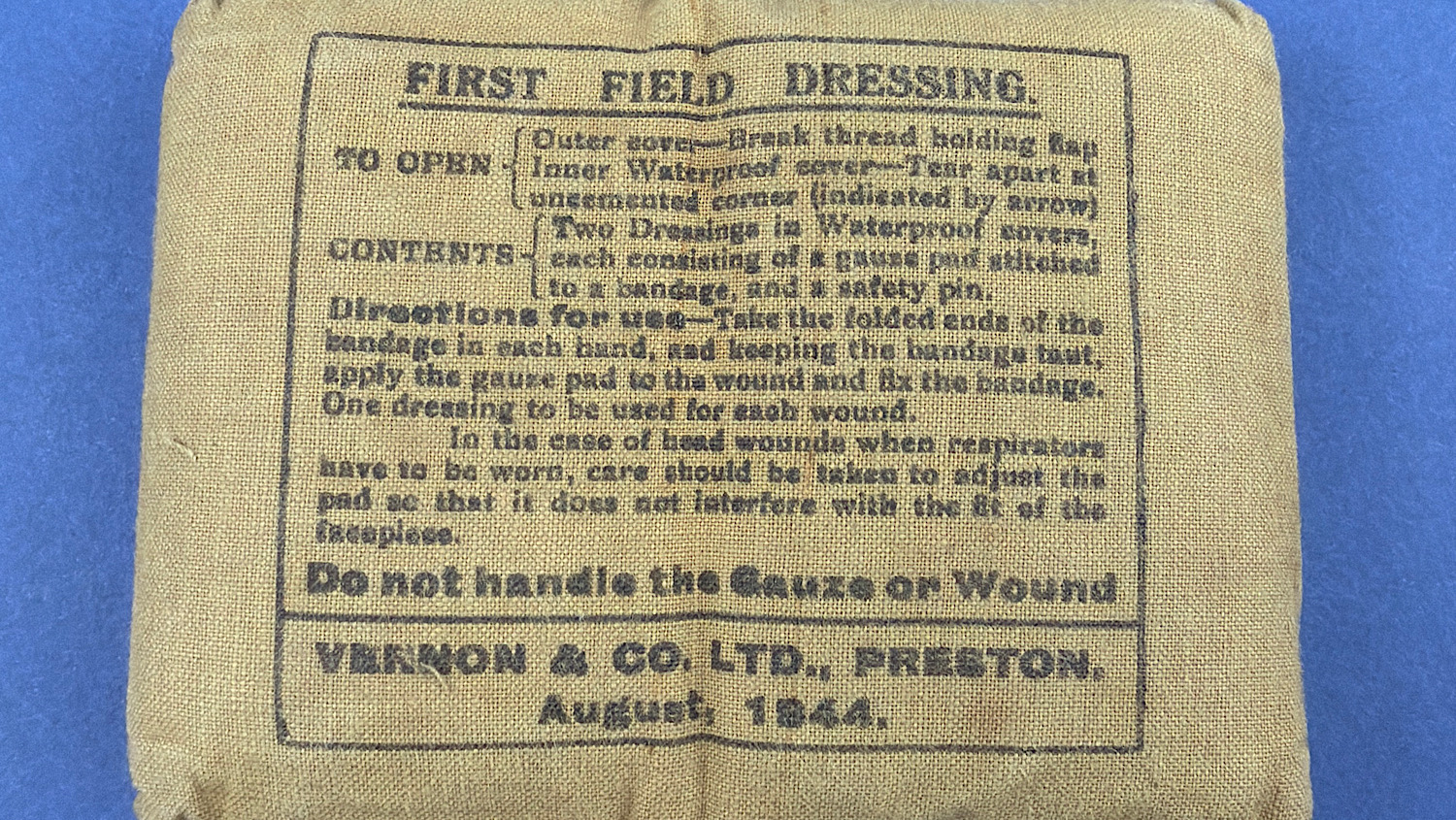 Front view of original WW2 British Army First Field Dressing dated August 1944 by Vernon & Co Ltd Preston