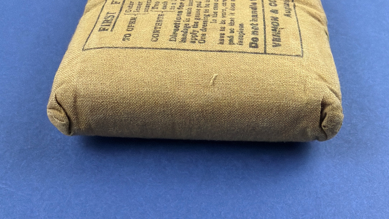 Low angle view of original WW2 British Army First Field Dressing showing sealed construction