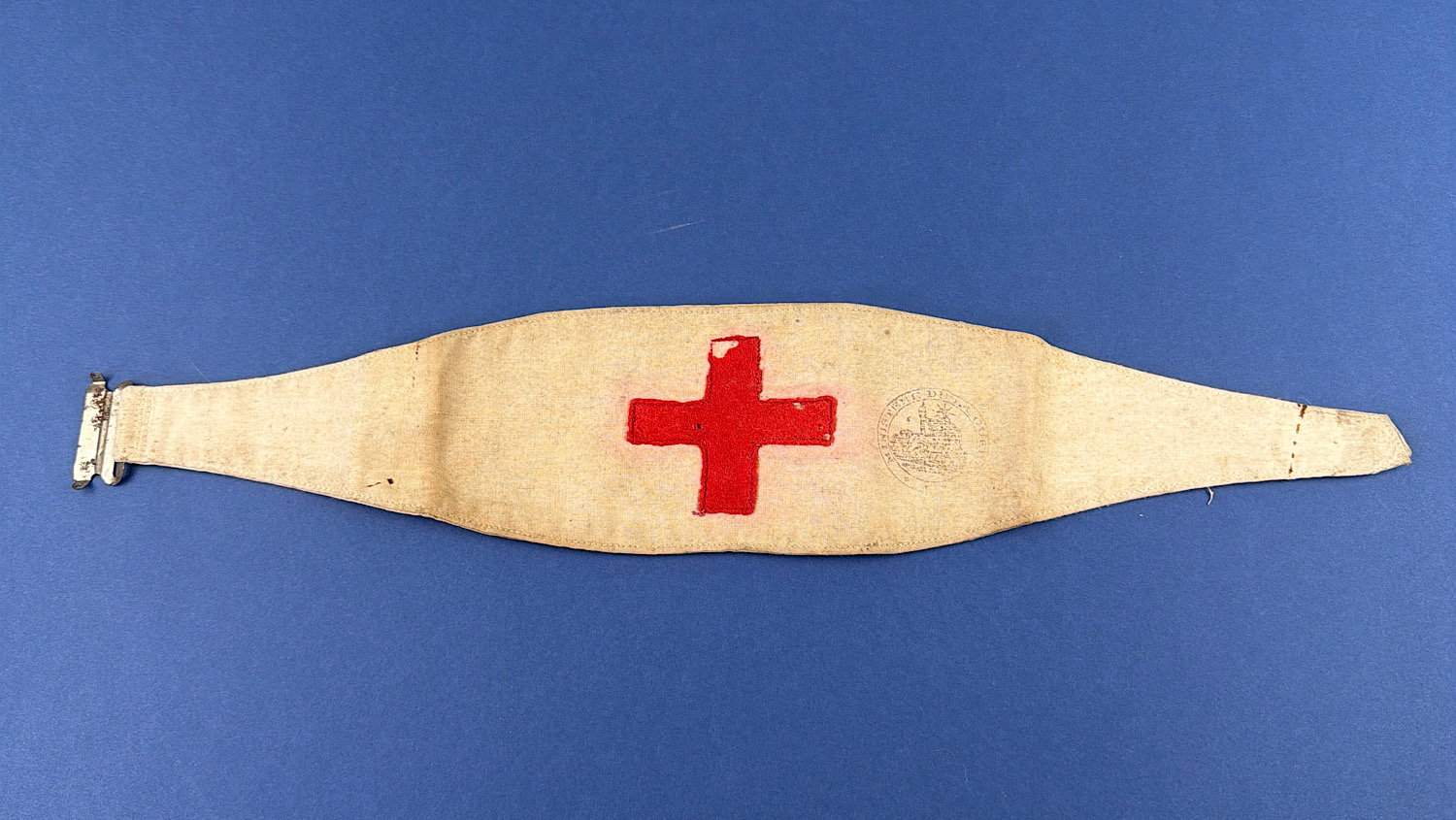 Original French WW1-era medical brassard with stitched red felt cross and faint ministry stamp, believed reused during WW2.
