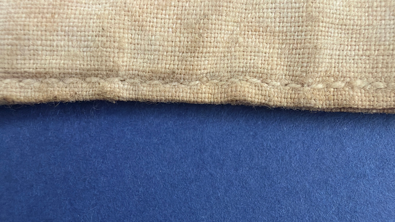 Close-up of the original stitching and coarse linen construction of the French medical brassard.