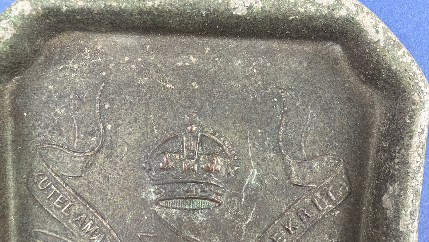Close-up of the 13th Hussars regimental crown and banner displaying the Latin motto Viret in Aeternum.