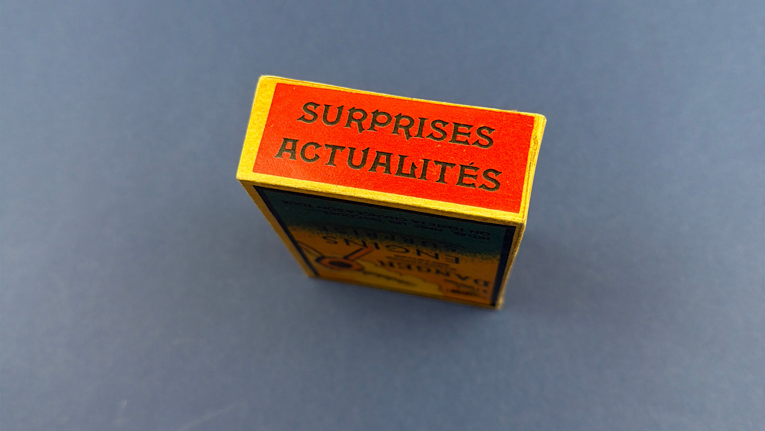 Top view of the original sealed WW2 French anti-Hitler propaganda dexterity toy box showing "Surprises Actualités".