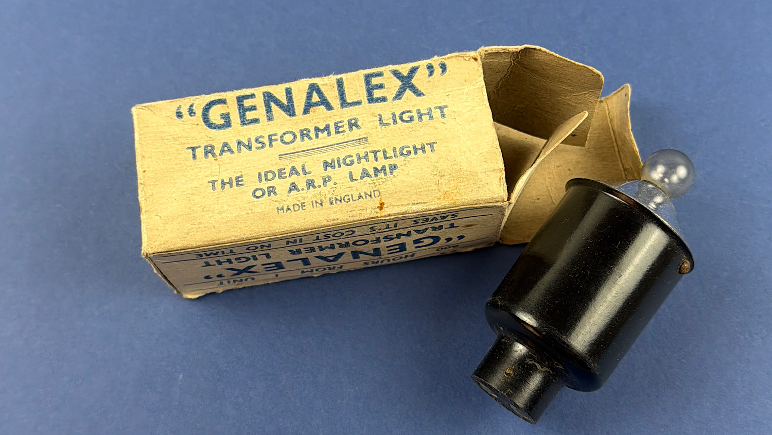 Original WW2 Home Front "Genalex" A.R.P. transformer night light displayed alongside its original illustrated cardboard box.