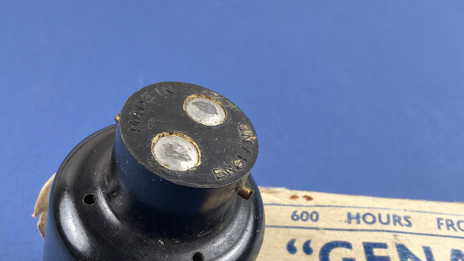 Angled close-up of the original "Made in England" two-pin plug fitted to the WW2 Genalex transformer light.
