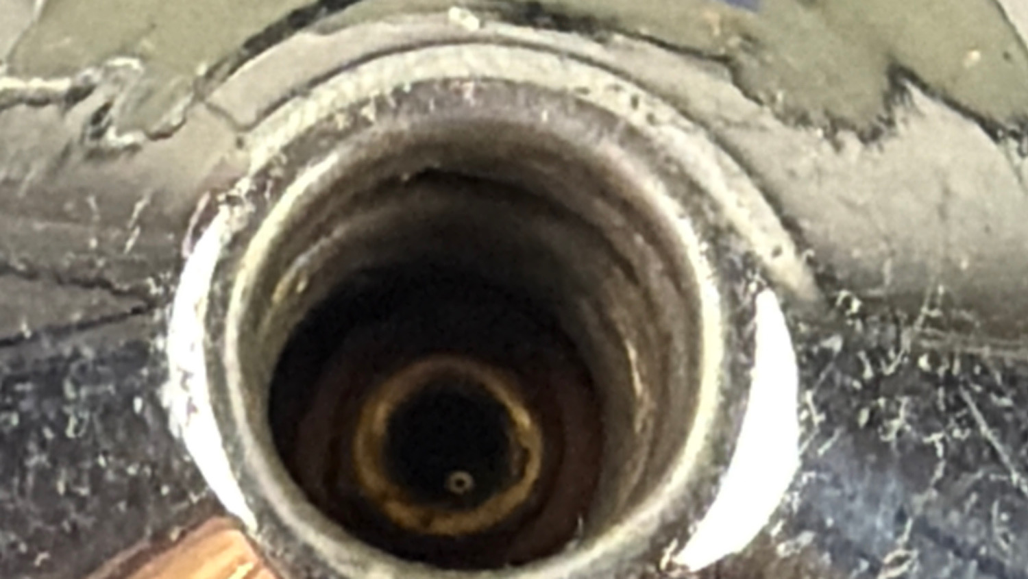 Close-up of the original lamp holder inside the WW2 Genalex transformer light showing the bulb socket and internal fitting.