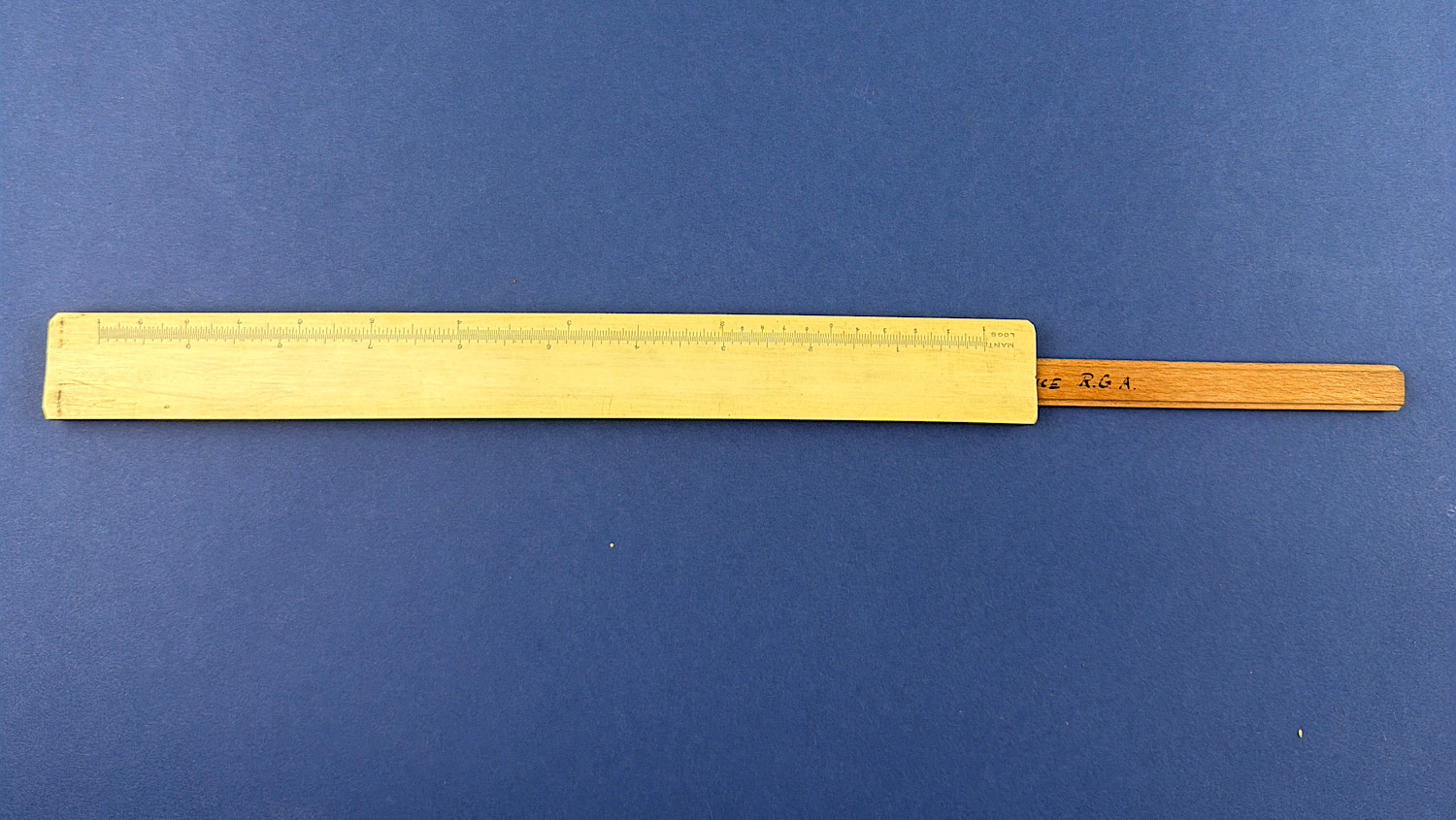 Full-length view of the original WW1 Royal Garrison Artillery named boxwood slide rule with extended slide.