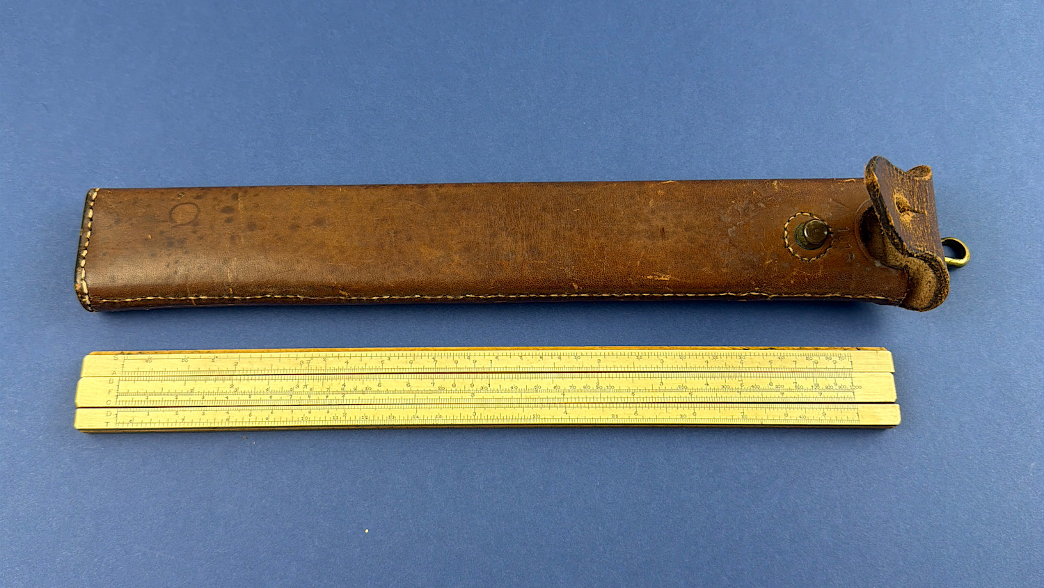 Original WW1 1916 dated Royal Garrison Artillery named boxwood slide rule with matching broad arrow leather case.
