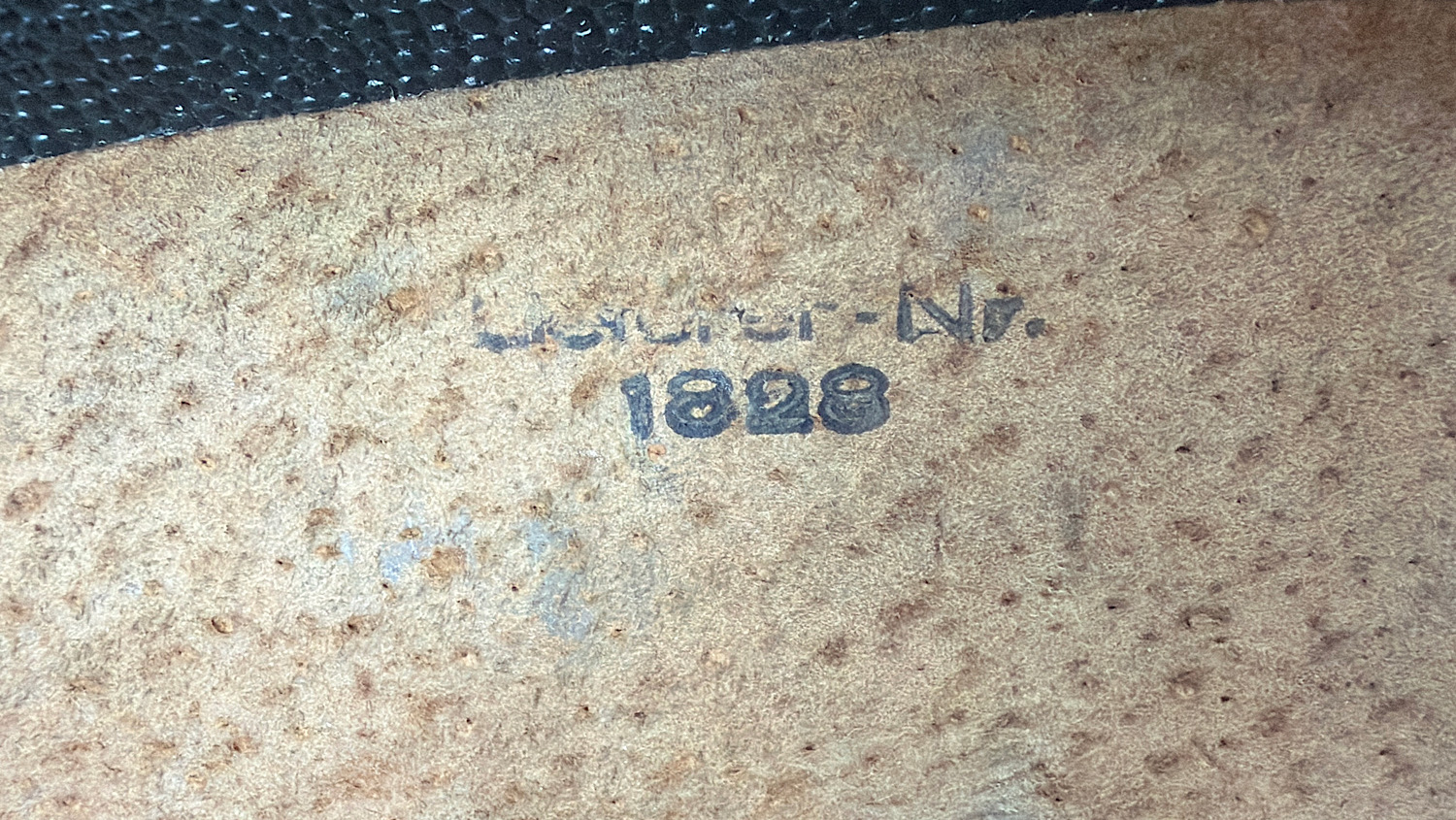 Interior stamp inside the original WW2 German flare pistol signal cartridge carrying case showing the partially legible '... N. 1928' marking.