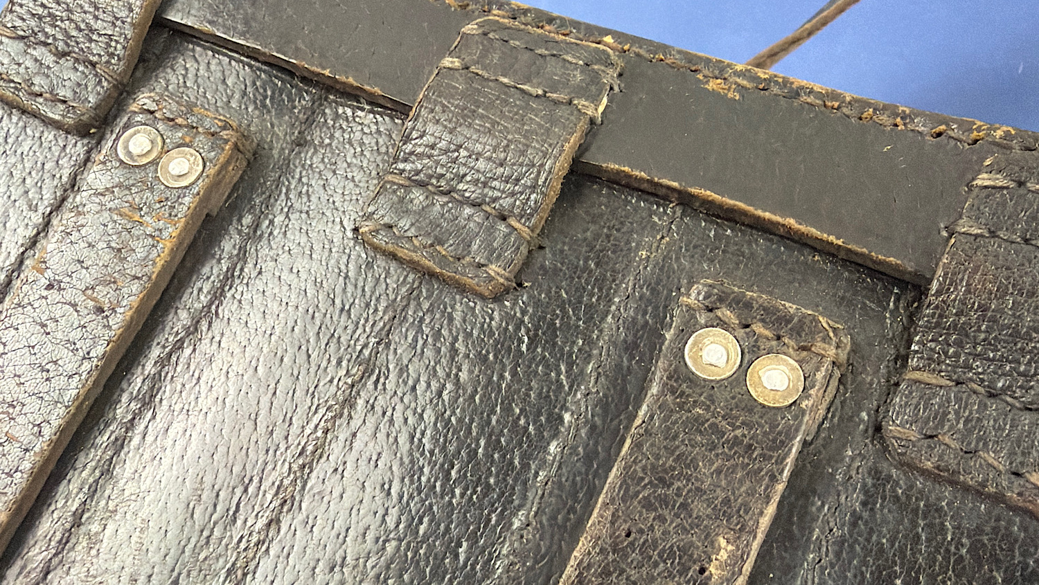 Rear detail of the original WW2 German leather flare pistol signal cartridge carrying case showing stitching, belt loops and riveted strap attachments.