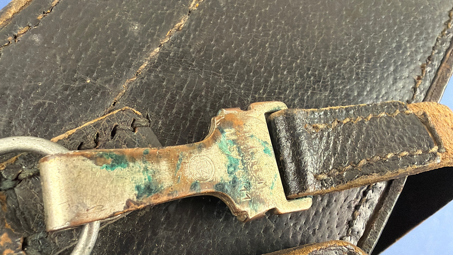 Close-up of the shoulder strap fitting on the original WW2 German flare pistol signal cartridge carrying case showing original wartime hardware and verdigris patina.